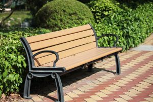 Park bench in the sunshine at a park